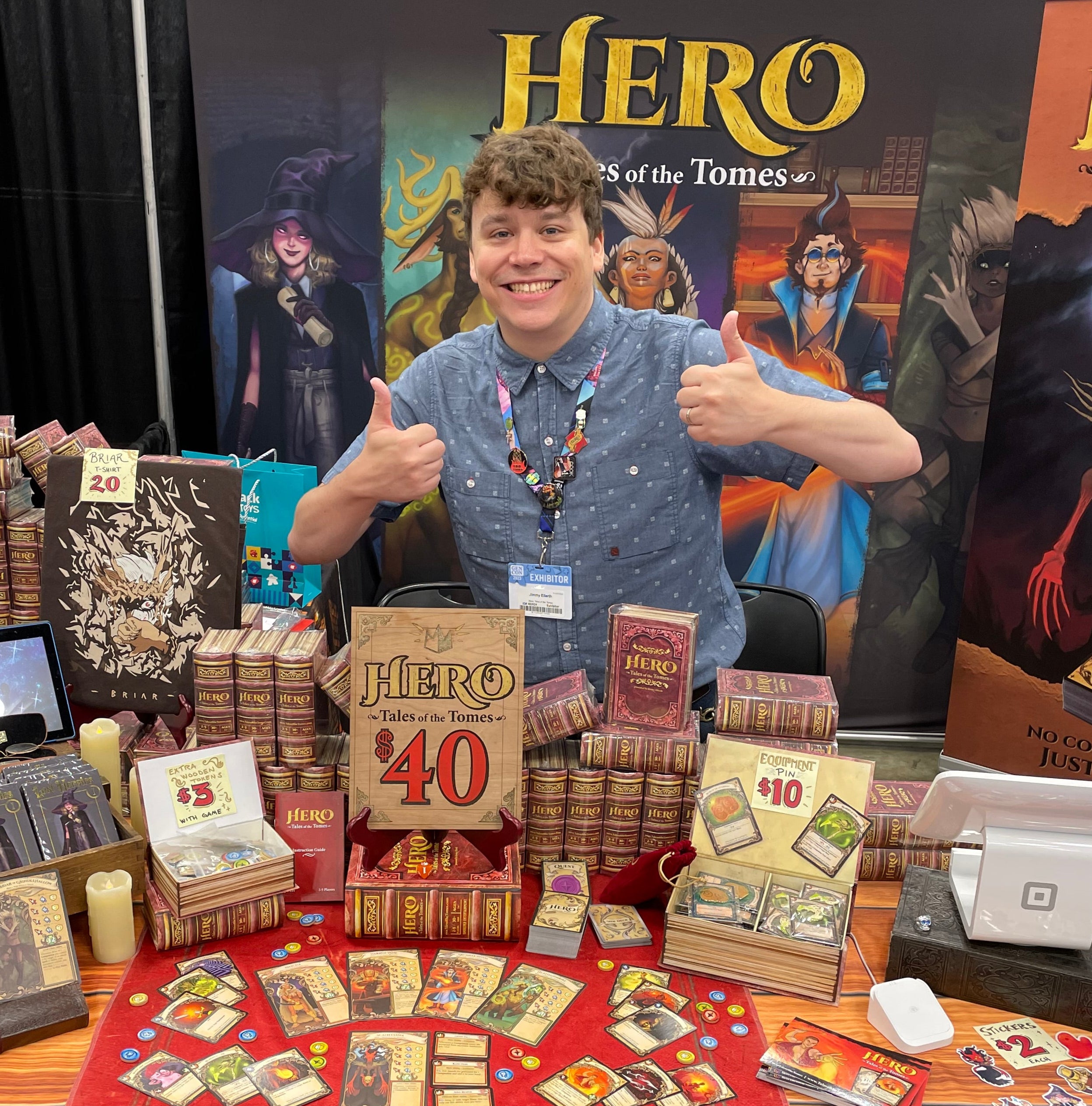 Creator Jimmy Ellerth at GenCon 2023 with Hero: Tales of the Tomes a fantasy card board strategy tabletop game for teens and adults that comes all in one book box